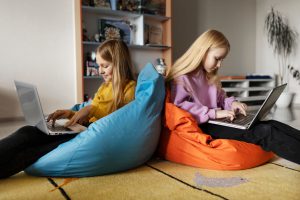 teens on beanbags with computer