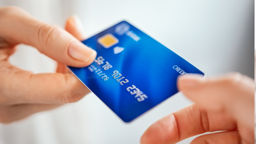 credit card being passed from one hand to another