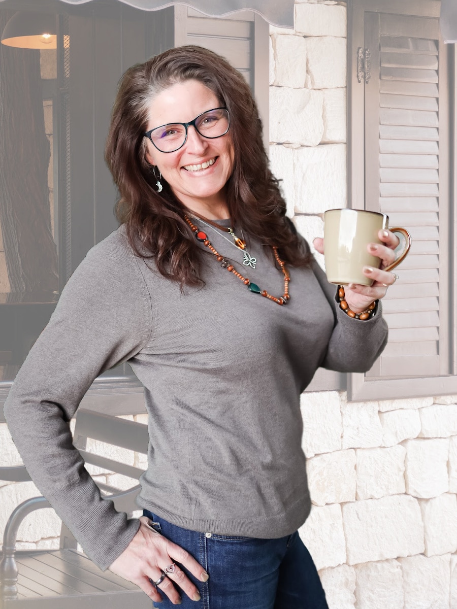 Lisa Williams - JoLi Design Solutions - holding coffee standing in front of coffee shop