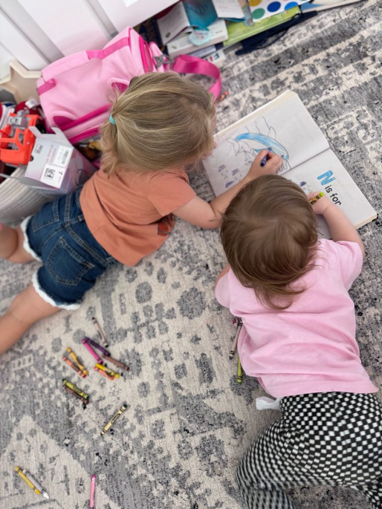 girls on floor coloring
